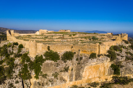 Aerial view of Cervera del Maestre castle with ruined excavated inner building remains surrounded by a partially restored outer wall of Arab originの写真素材