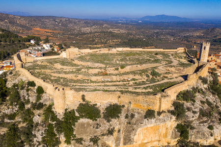 Aerial view of Cervera del Maestre castle with ruined excavated inner building remains surrounded by a partially restored outer wall of Arab originの写真素材