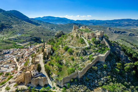 Moclin medieval walled town and ruined castle near Granada Spain with blue sky aerial panoramaのeditorial素材