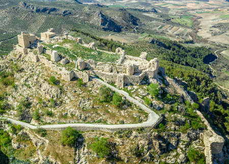 Moclin medieval walled town and ruined castle near Granada Spain with blue sky aerial panoramaのeditorial素材