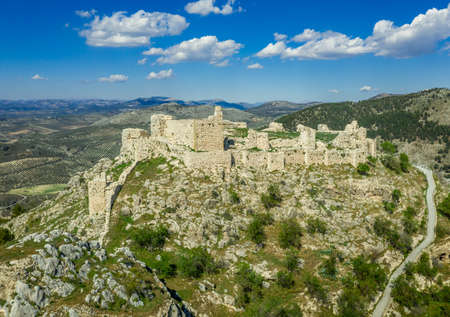 Moclin medieval walled town and ruined castle near Granada Spain with blue sky aerial panoramaのeditorial素材