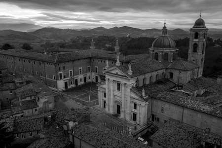 Aerial view of the Ducal Palace of Urbino medieval walled town and university in Marche, Italy with blue sky, popular travel destinationのeditorial素材