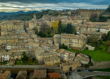 Aerial view of the Ducal Palace of Urbino medieval walled town and university in Marche, Italy with blue sky, popular travel destinationのeditorial素材