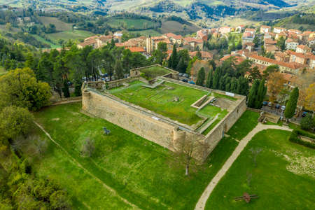 Aerial view of the Rocca medieval fortification in Urbino medieval walled town and university in Marche, Italy with blue sky, popular travel destinationのeditorial素材
