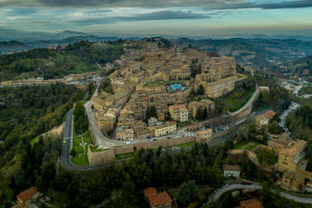 Aerial view of the Ducal Palace of Urbino medieval walled town and university in Marche, Italy with blue sky, popular travel destinationのeditorial素材