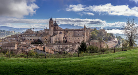 Aerial view of the Ducal Palace of Urbino medieval walled town and university in Marche, Italy with blue sky, popular travel destinationのeditorial素材