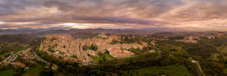 Aerial view of the Ducal Palace of Urbino medieval walled town and university in Marche, Italy with blue sky, popular travel destinationのeditorial素材