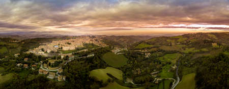 Aerial view of the Ducal Palace of Urbino medieval walled town and university in Marche, Italy with blue sky, popular travel destinationのeditorial素材
