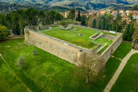 Aerial view of the Ducal Palace of Urbino medieval walled town and university in Marche, Italy with blue sky, popular travel destinationのeditorial素材