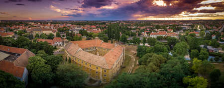 Dramatic colorful sky over Mosonmagyarovar castle and church at sunsetのeditorial素材