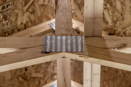 Close up of galvanized metal connector plates, rafter for wood, trusses, holding up beams for a new...
