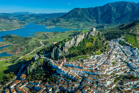 Aerial view of Zahara de la Sierra one of the white towns or Pueblos Blancos, in Andalucia Spain, with a ruined medieval castle and the man made lake formed by the Guadalete river high damnのeditorial素材