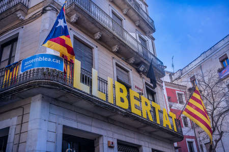 yellow red blue Catalan flag flying proudly on independence party houses in Girona
