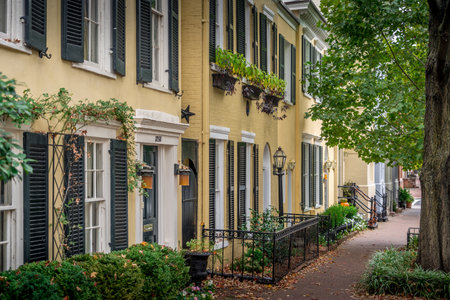 Real Estate: upscale, luxury historic  townhouse facade colonial Georgian style symmetric double pan windows dark shutters, yellow, gray, blue, painted brick, molding in Georgetown, Washington DC quaiのeditorial素材