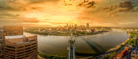 Aerial view of downtown Cincinnati with dramatic orange yellow sunset skyのeditorial素材