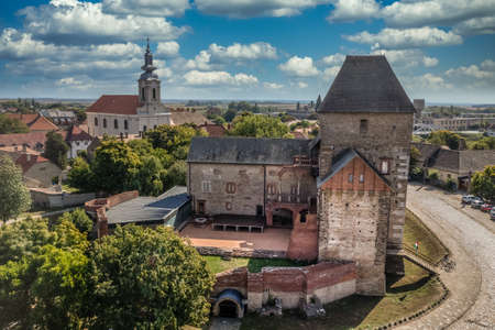 Aerial view of medieval Gothic Simontornya castle protecting the cross on the Sio river  in Tolna county Hungary with restored donjon, palace, brick walls blue cloudy skyのeditorial素材