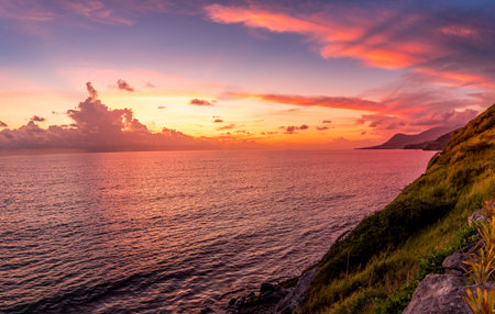 Dramatic Caribbean sea sunset view with orange, red, purple sky in St. Kitts and Nevisの写真素材