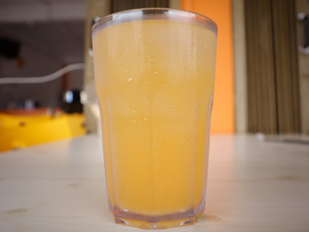 Orange juice in a glass with ice on the table, stock photoの写真素材
