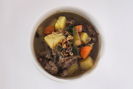 Lamb soup with potatoes and vegetables in a bowl on white backgroundの写真素材