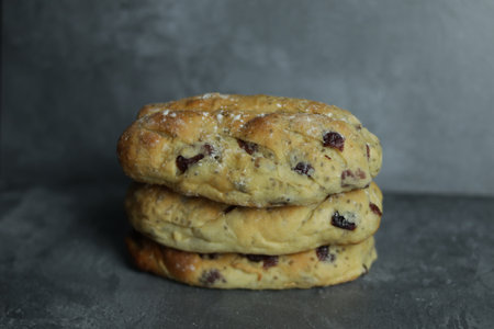 Stack of delicious cookies with raisins on table, closeup