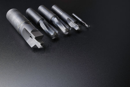cutting tools set (drill, reamer, endmill). used for metalwork. Material carbide and steel. Isolated on dark background.の写真素材