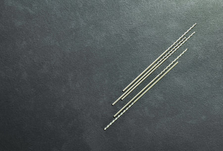 drill bits small special cutting tools. right spiral. Carbide coating high speed. On black background. Make holes part automotive. Drilling metal, steel, cast iron, Aluminum, stainless.の写真素材