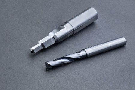 cutting tools special set. Drill oil hole, reamer. spiral right hand. material Carbide and high speed steel, coating Titanium nitride. isolated on dark background.の写真素材