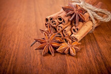 cinnamon sticks and star anise on a wooden backgroundの写真素材