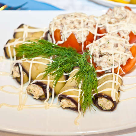 Stuffed tomatoes and eggplant rolls on the tableの写真素材