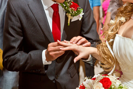 The groom wears the ring brideの写真素材