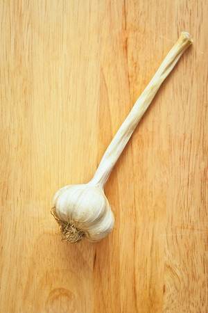 Head of garlic on a wooden boardの写真素材