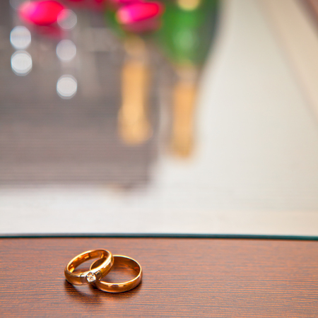 Wedding rings on a tableの写真素材