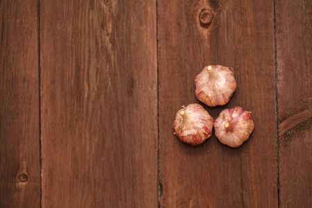 Ripe garlic head on a wooden backgroundの写真素材