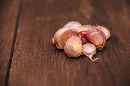 garlic cloves on a wooden backgroundの写真素材