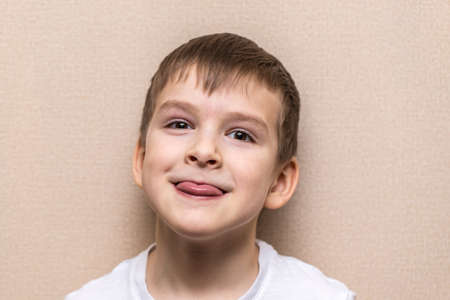 close-up portrait of a boy of six years old. Shows language