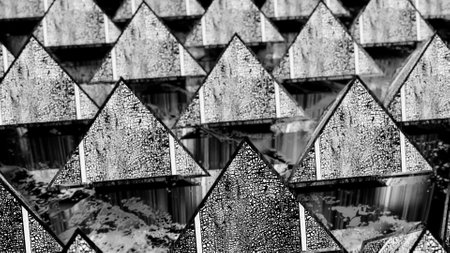 background from rows of black and white cracked pyramids. abstract three-dimensional composition. 3d...