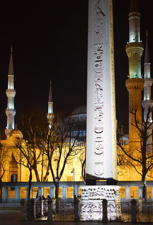 ISTANBUL, TURKEY - FEBRUARY 12, 2014: Egyptian Obelisk, Luxor at the Hippodrome of Constantinople with the Blue Mosque in the background at night, Istanbul, Turkey.のeditorial素材