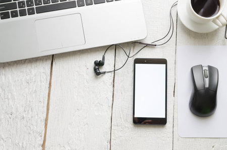 View of a Laptop in high definition  coffee and mobile phone with on woodden white background