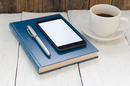 Coffee cup and book with wooden white backgroundの写真素材