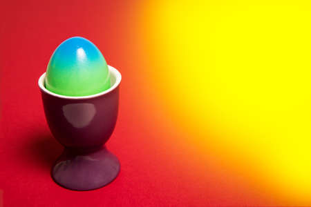 Colorfull easter egg on a yellowred background