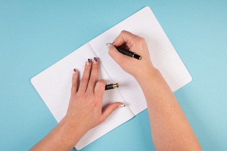 writing on the lines of a notebookの写真素材