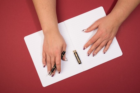 holding a ink pen in open handの写真素材