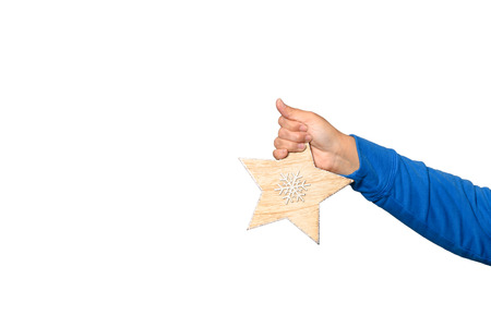 A hand is holding a poinsettia against a white background
