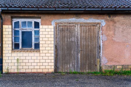 A house with old beautiful windows and a wooden doorの写真素材