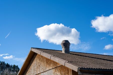 A chimney with a small white cloud