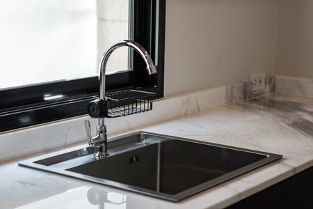 Close up of modern kitchen faucet and sinkの写真素材