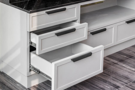 Close-up of the room's white wood cabinetsの写真素材