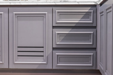 Close-up of the room's white wood cabinetsの写真素材
