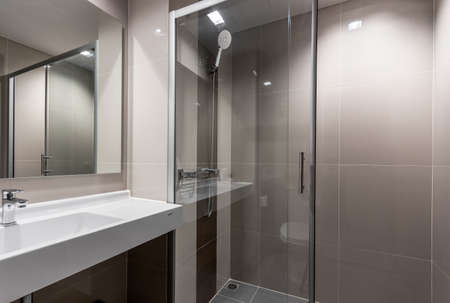 Clean and white bathroom with amenities.の写真素材