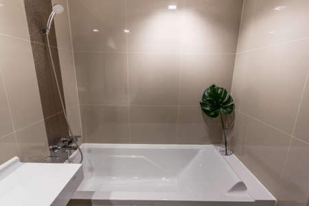 Clean and white bathroom with amenities.の写真素材